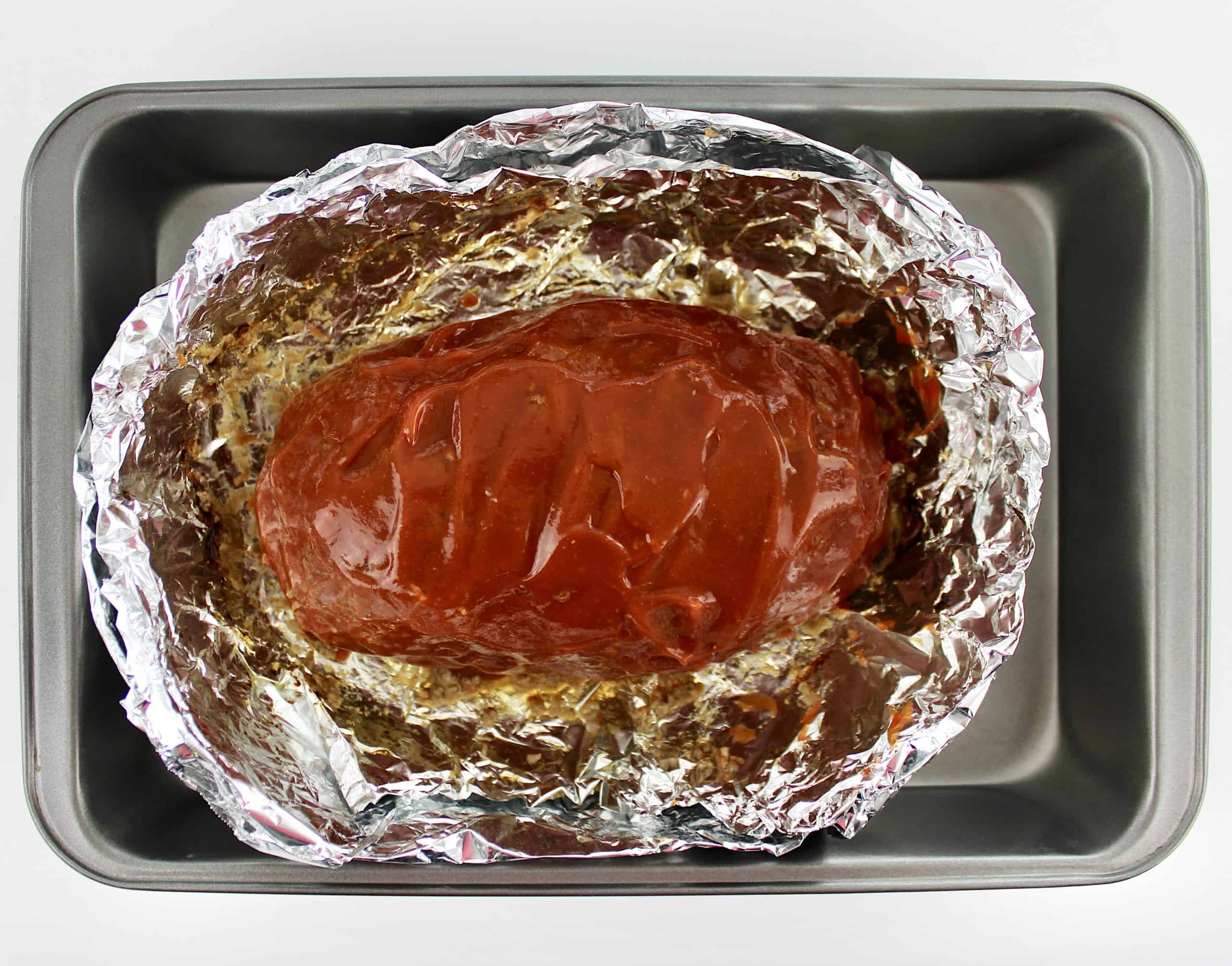 cooked Keto Crockpot Meatloaf in foil lined baking pan