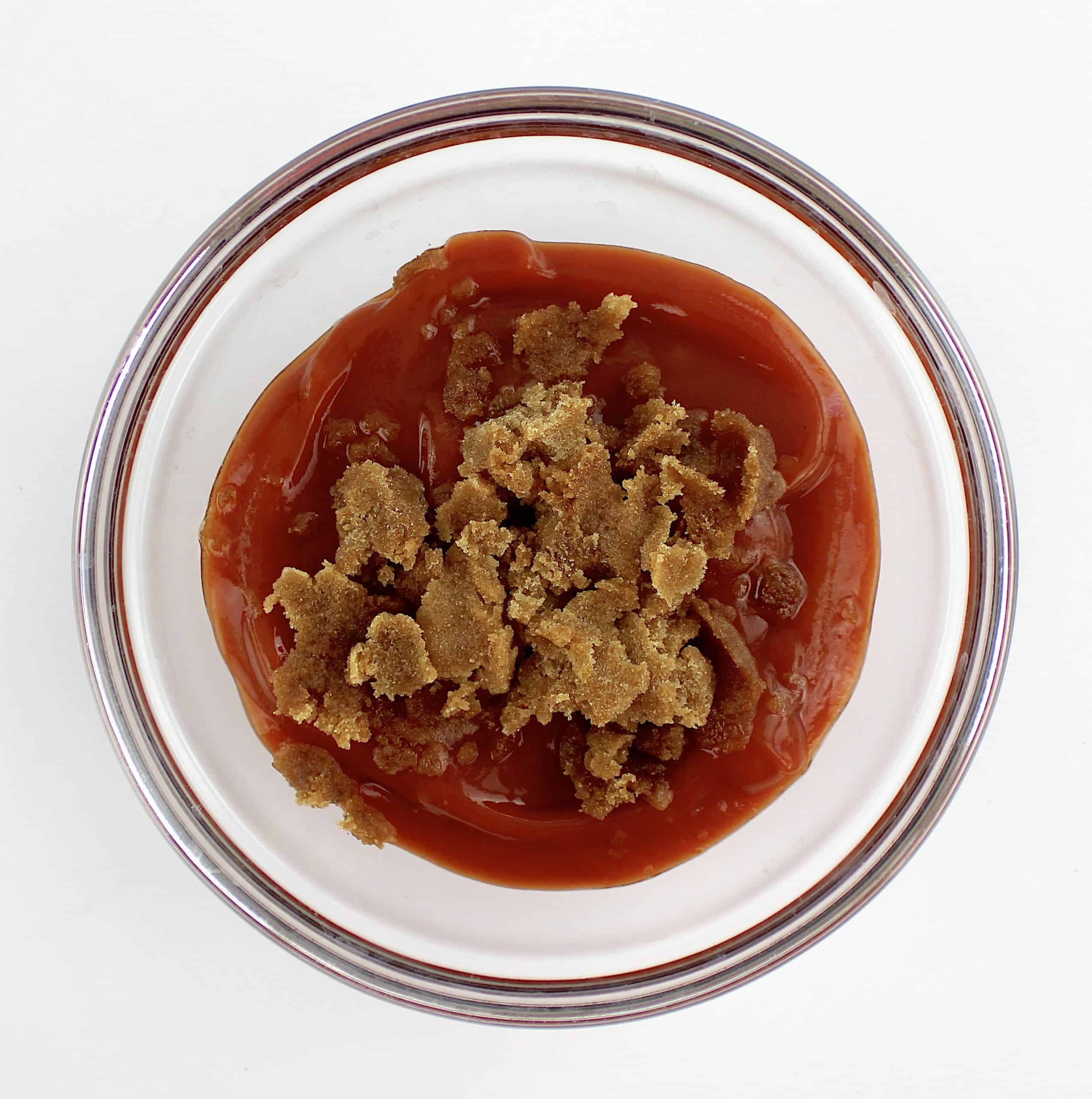brown sweetener and ketchup in glass bowl unmixed