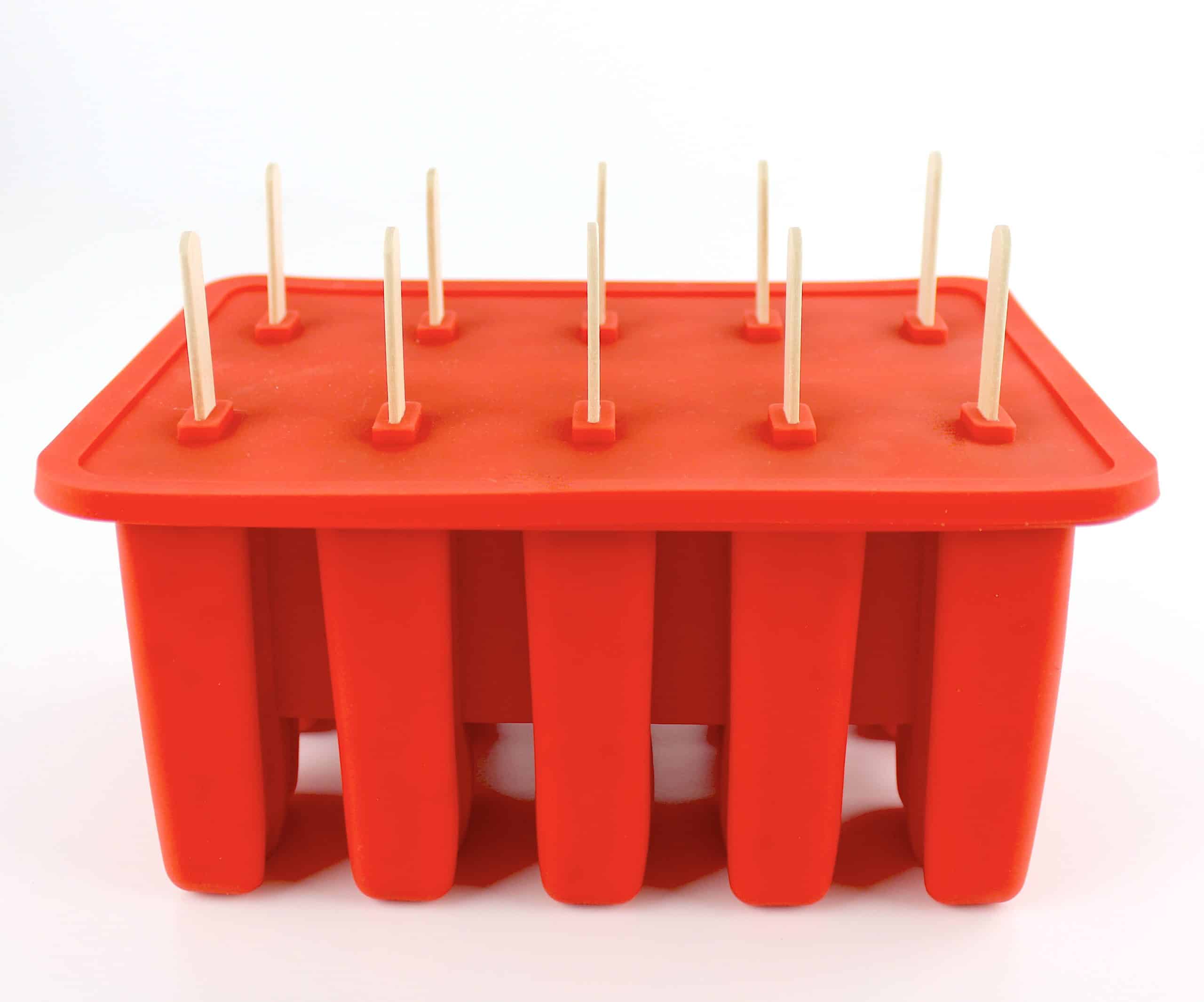 red silicone popsicle mold with cover and popsicle sticks