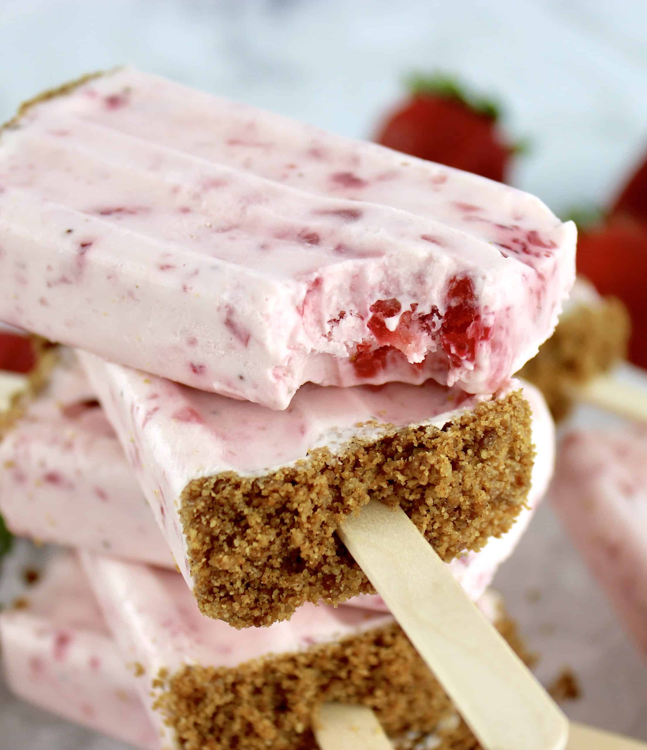closeup of Keto Strawberry Cheesecake Popsicle with bite missing