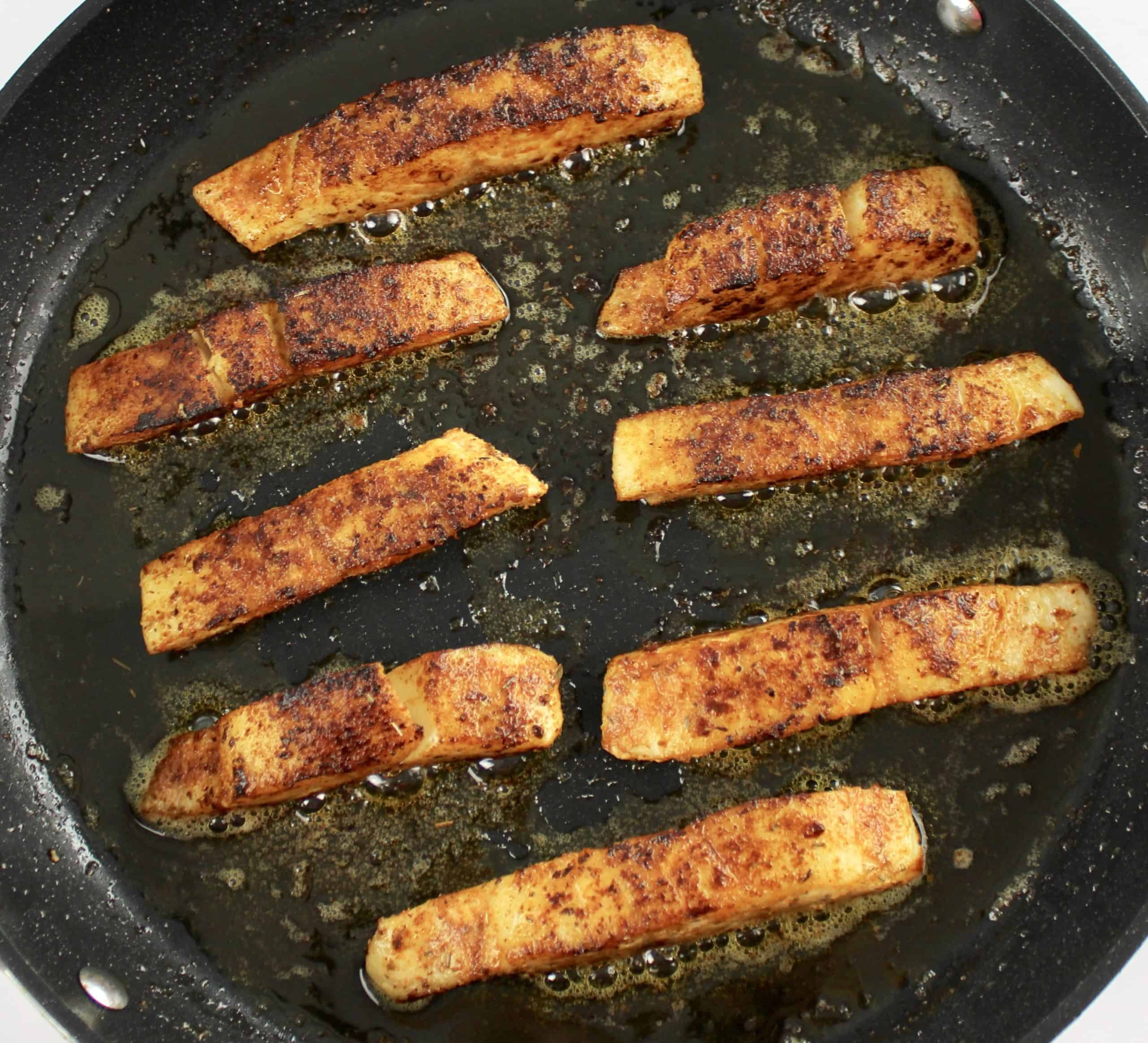 8 strips of cooked mahi mahi with blackening seasoning in skillet