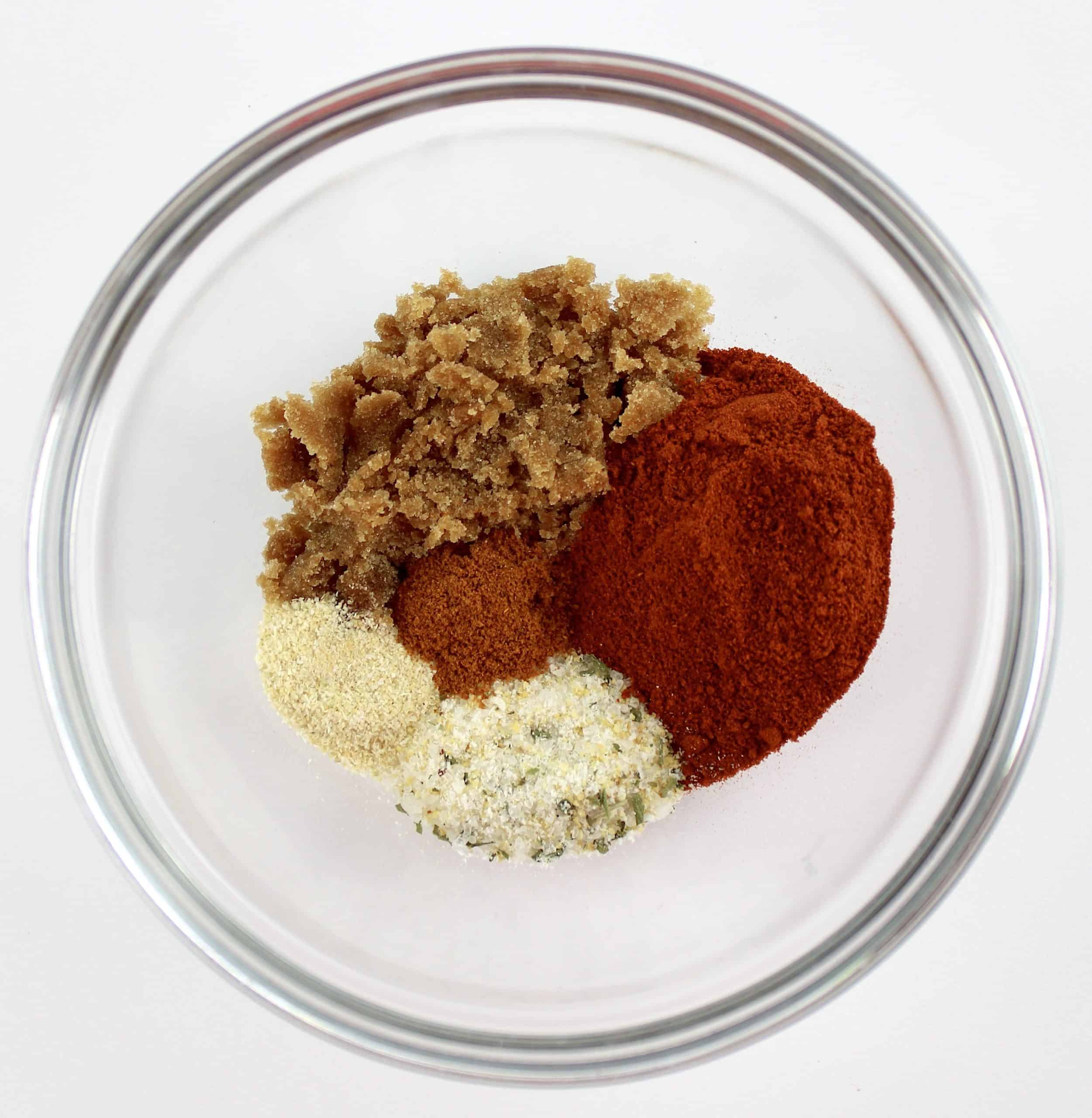 spices and brown sweetener in glass bowl unmixed
