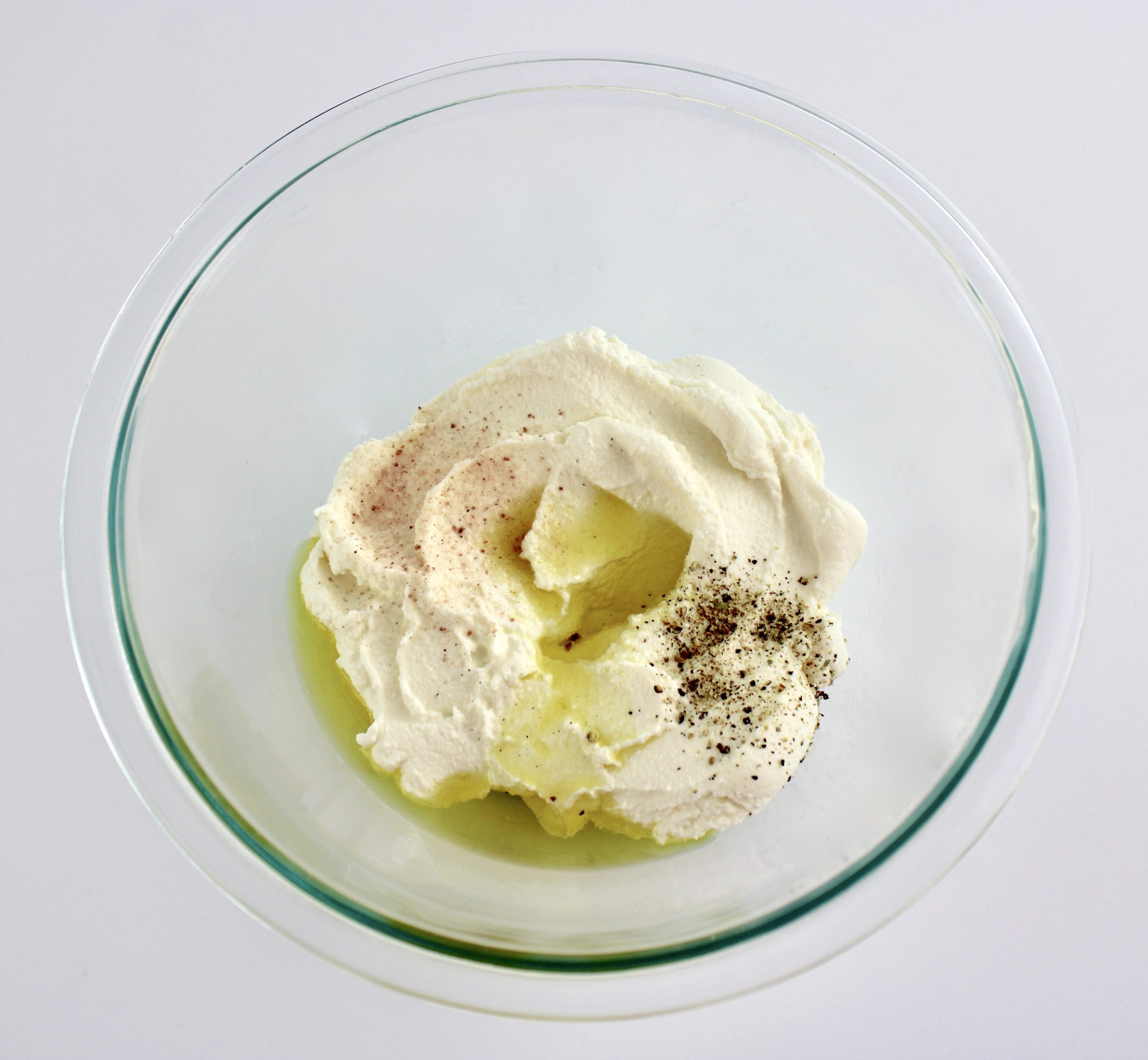 ricotta olive oil salt and pepper in mixing bowl unmixed