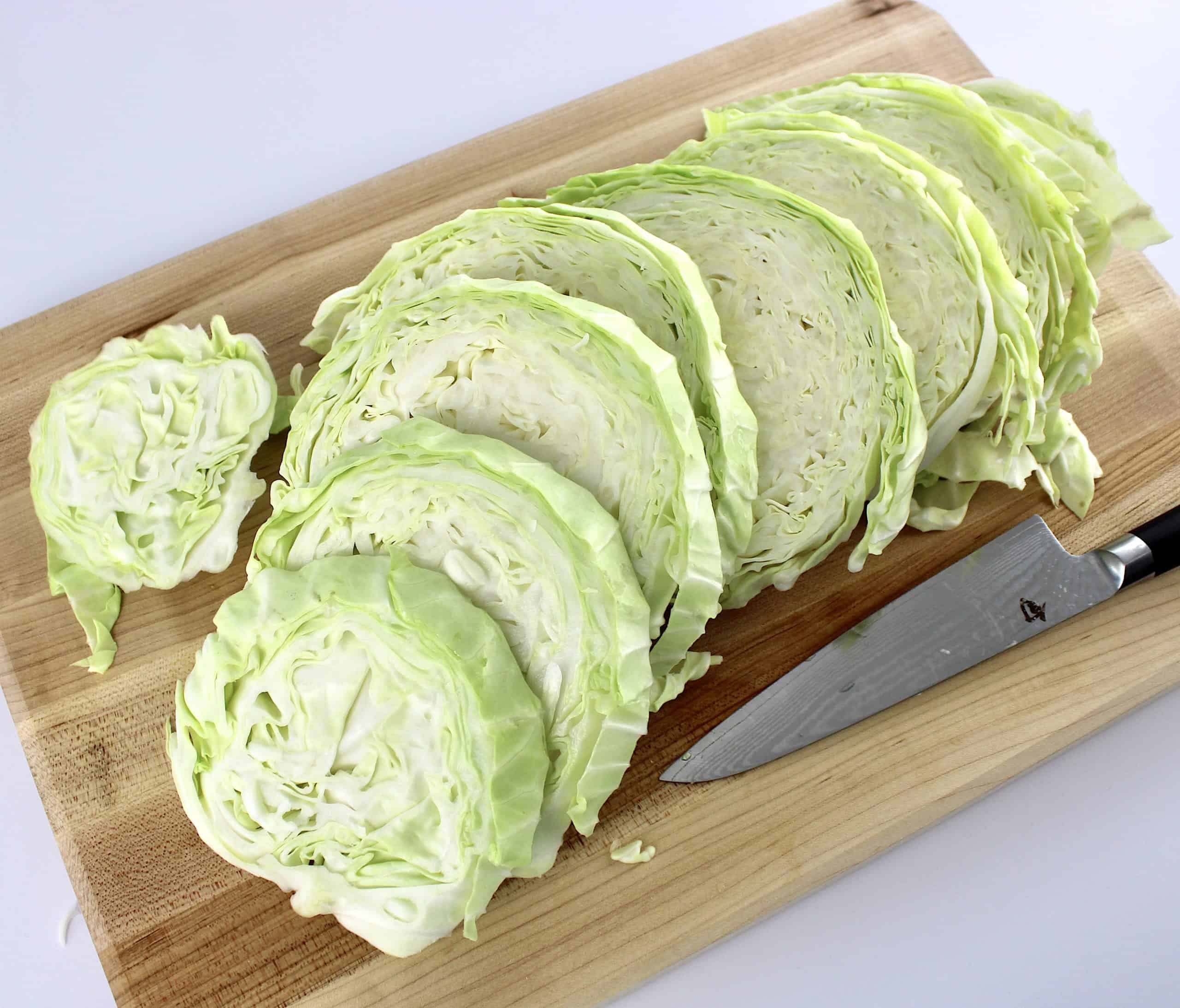 sliced raw cabbage steaks on cutting board