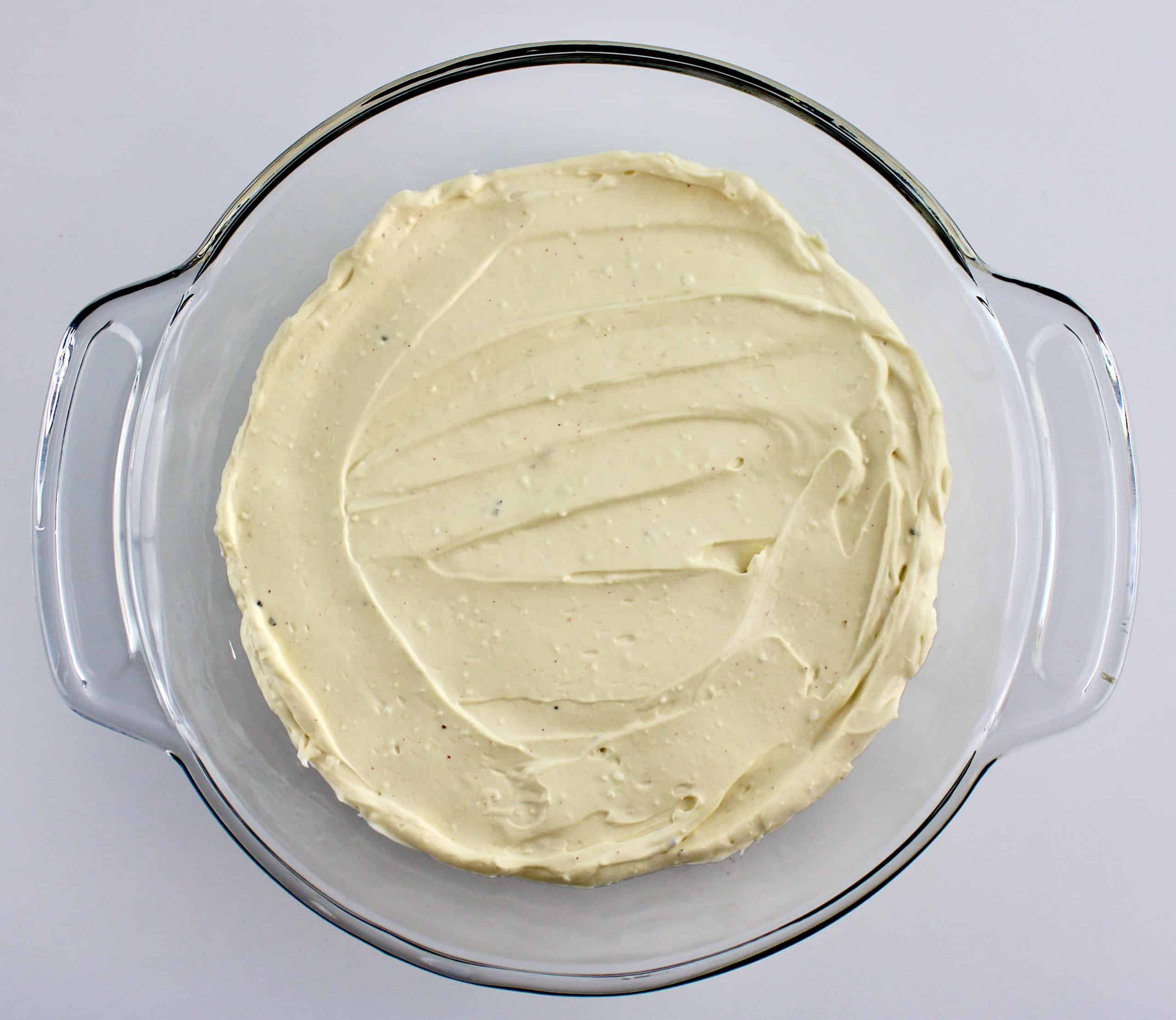 sour cream cream cheese and chipotle being mixed with hand mixer in glass bowl