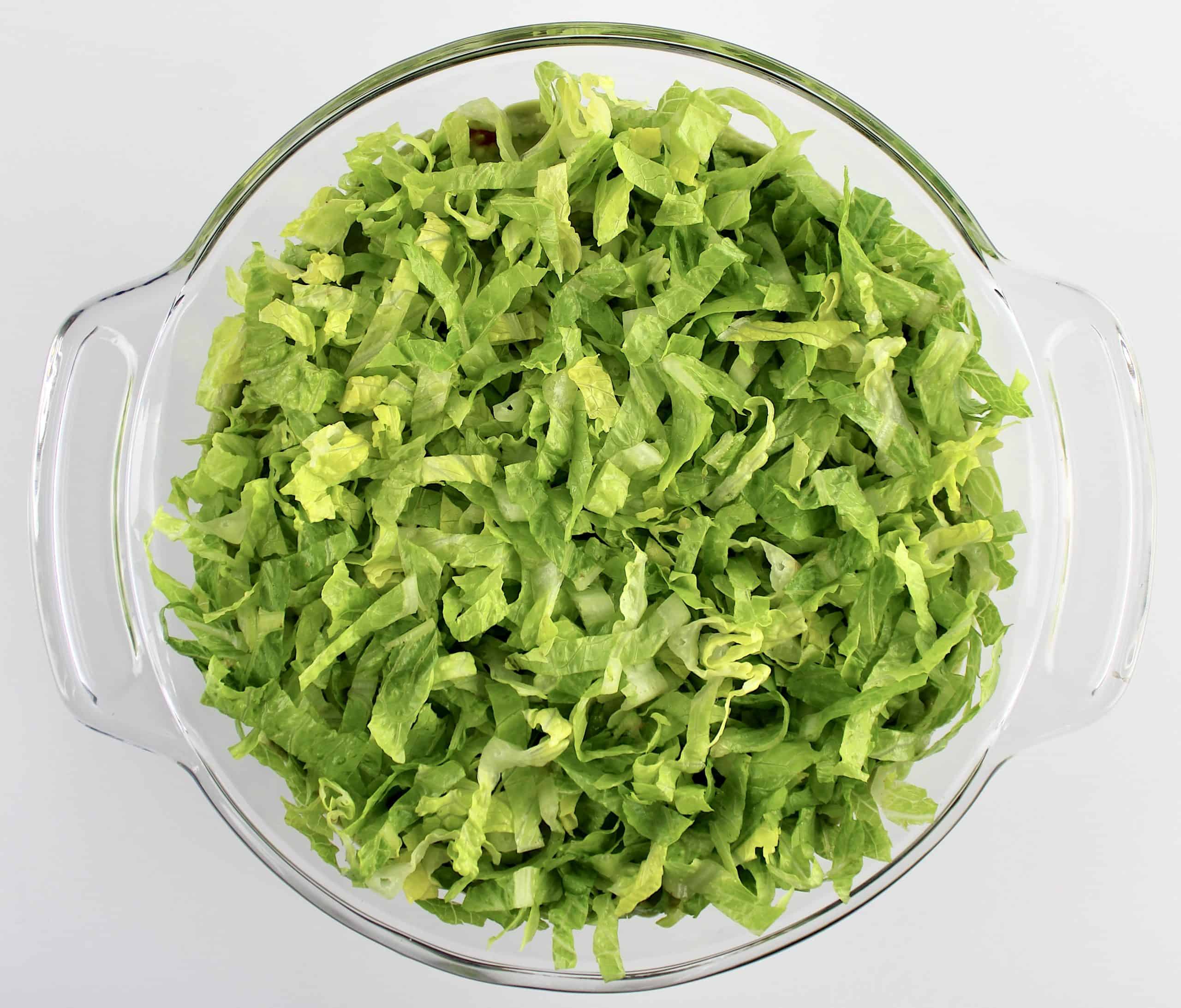 shredded lettuce in glass bowl
