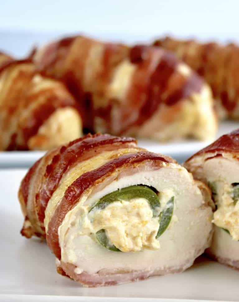 Bacon Wrapped Jalapeño Popper Chicken cut in half showing cheese filled pepper