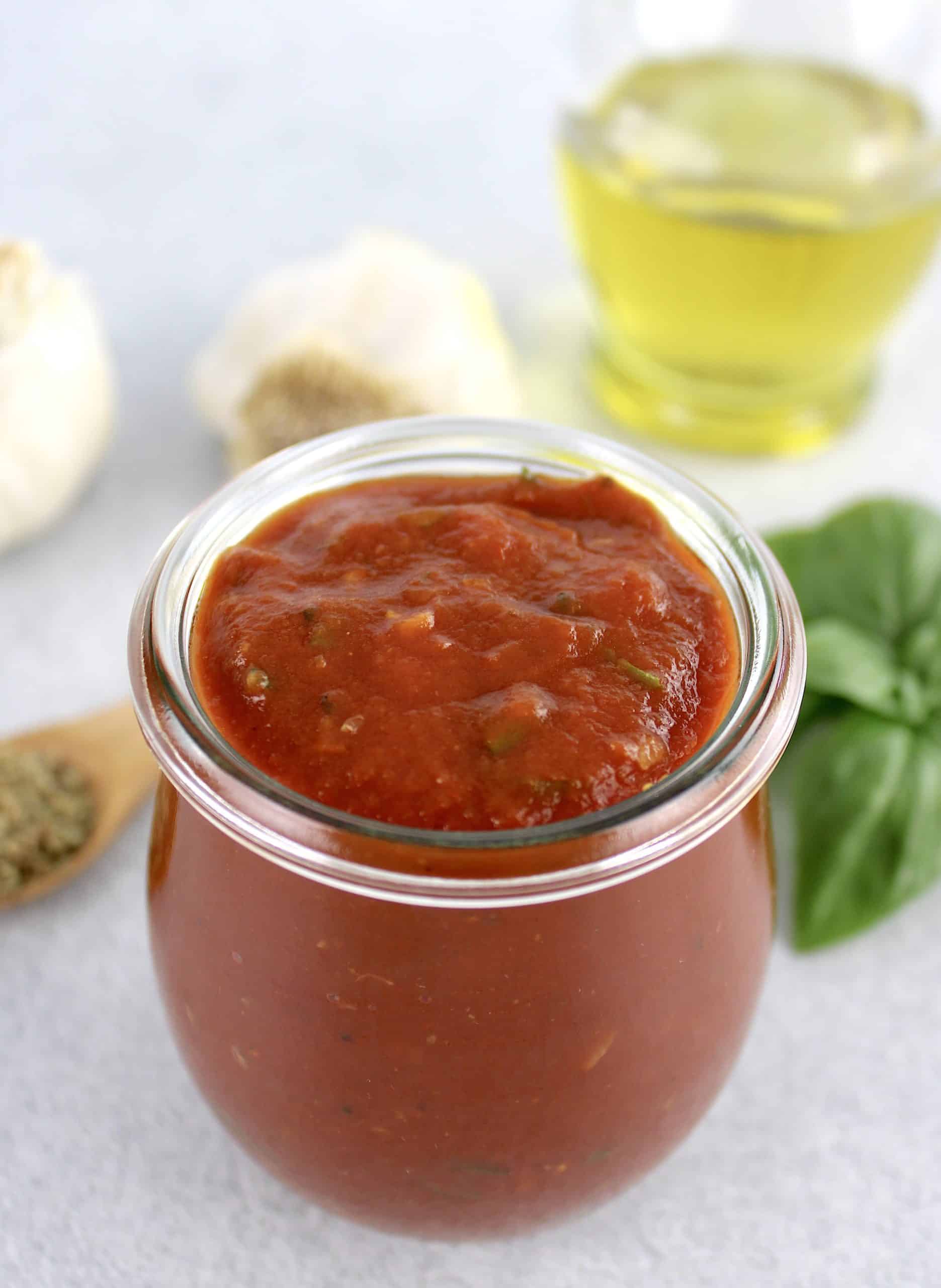 overhead view of pizza sauce in open glass jar