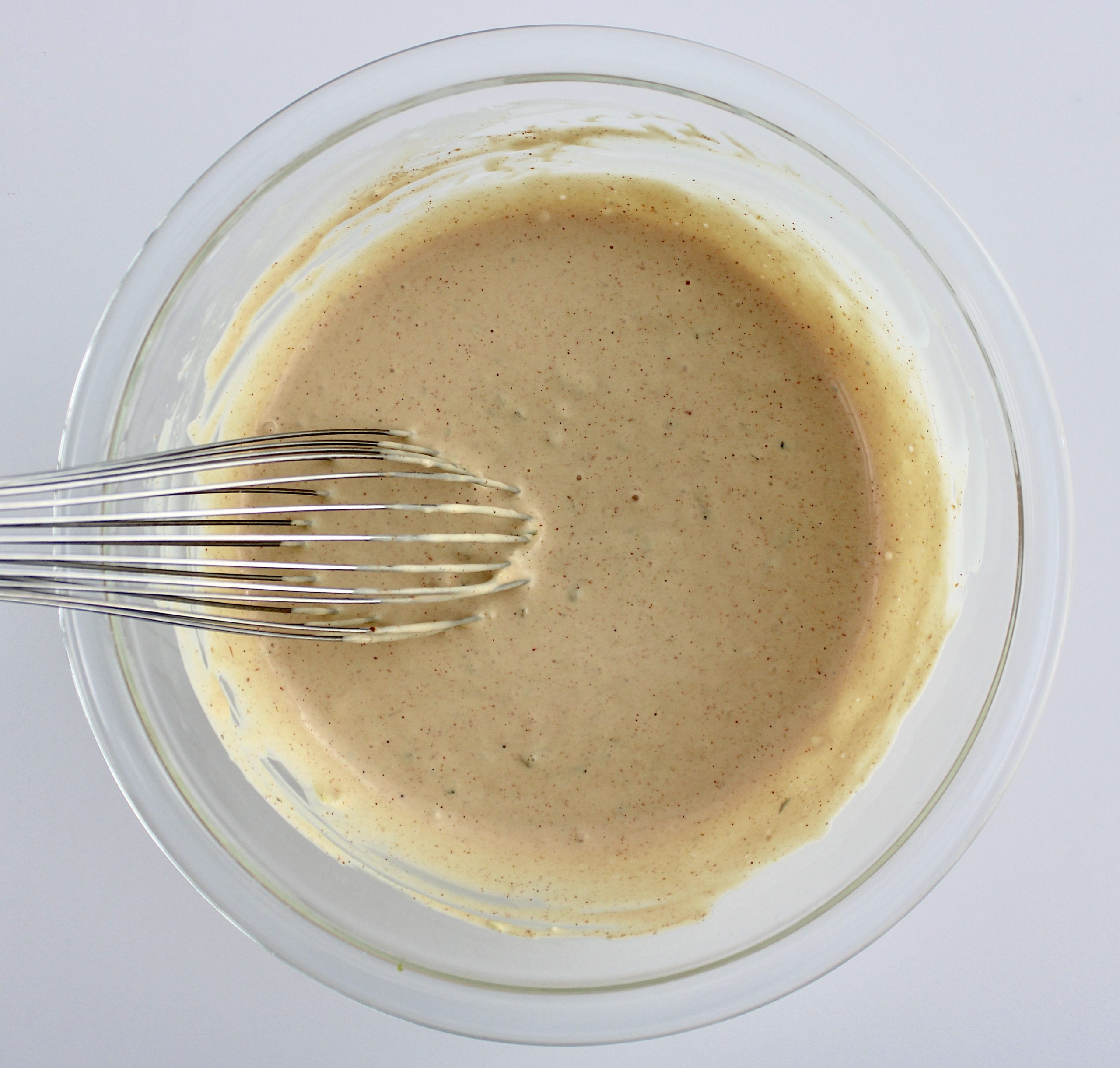 big mac salad special sauce dressing in glass bowl with whisk