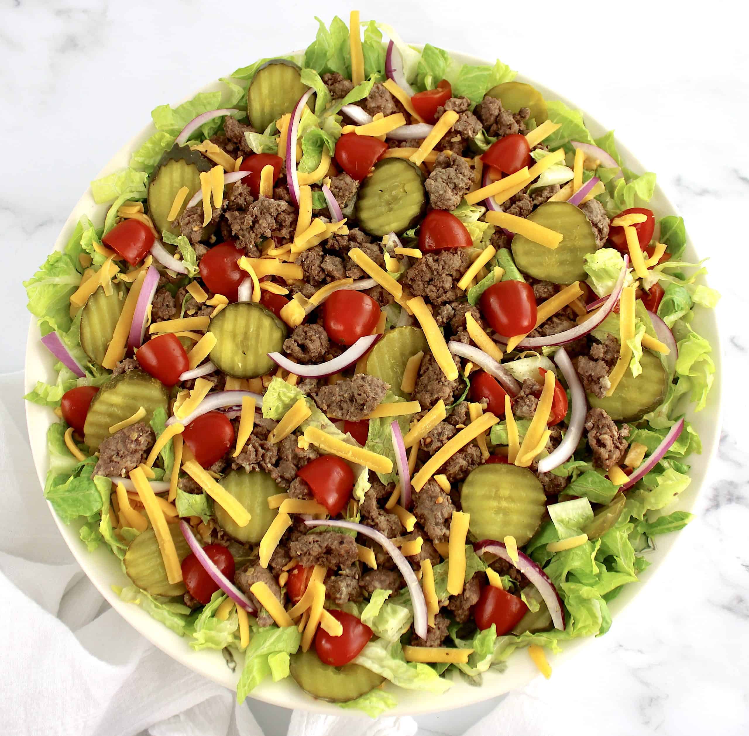 Big Mac Cheeseburger Salad in beige bowl without dressing