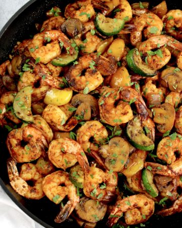 Garlic Butter Shrimp and Veggies Skillet with chopped parsley