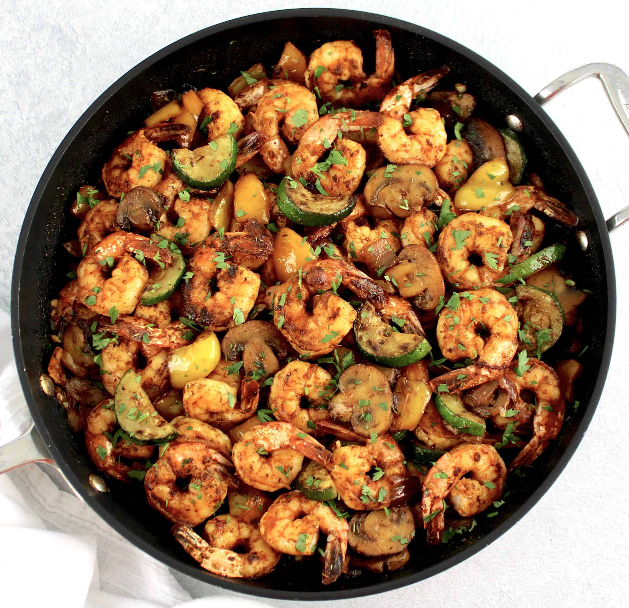 Garlic Butter Shrimp and Veggies in skillet with chopped parsley