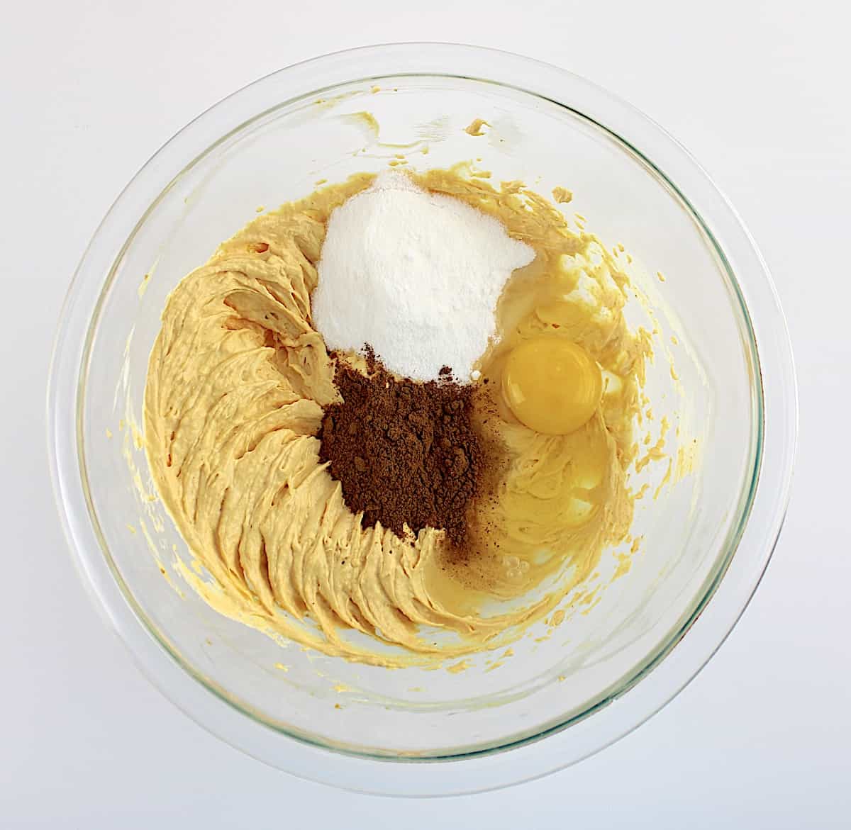 Keto Pumpkin Cheesecake Bars pumpkin layer ingredients in glass bowl unmixed