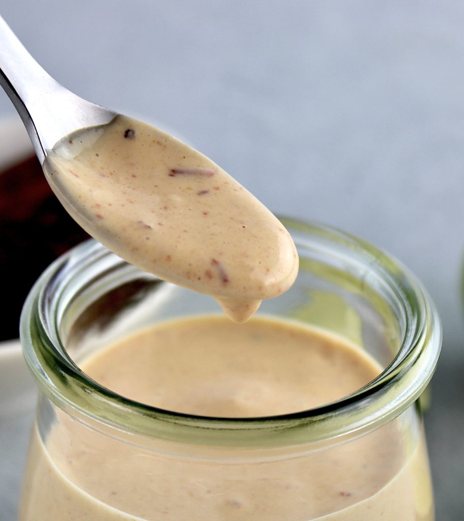 Chipotle Aioli being spooned out of open glass jar