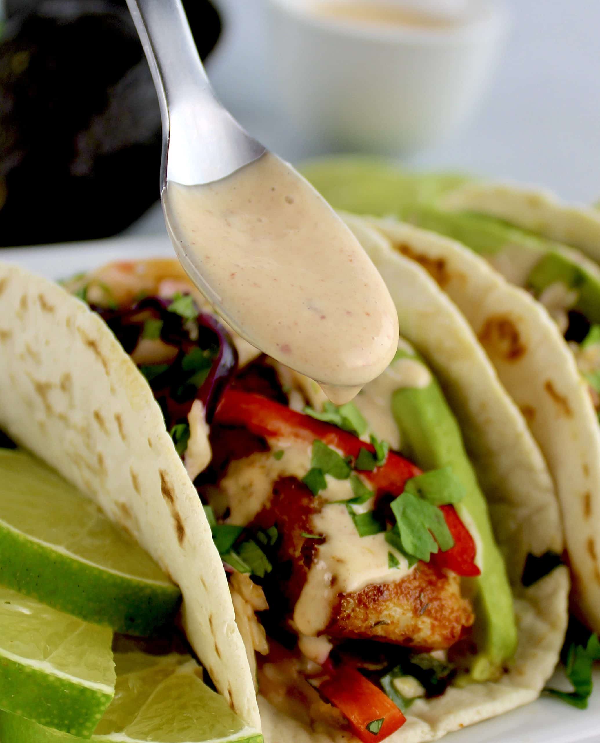 Chipotle Aioli being spooned over fish taco