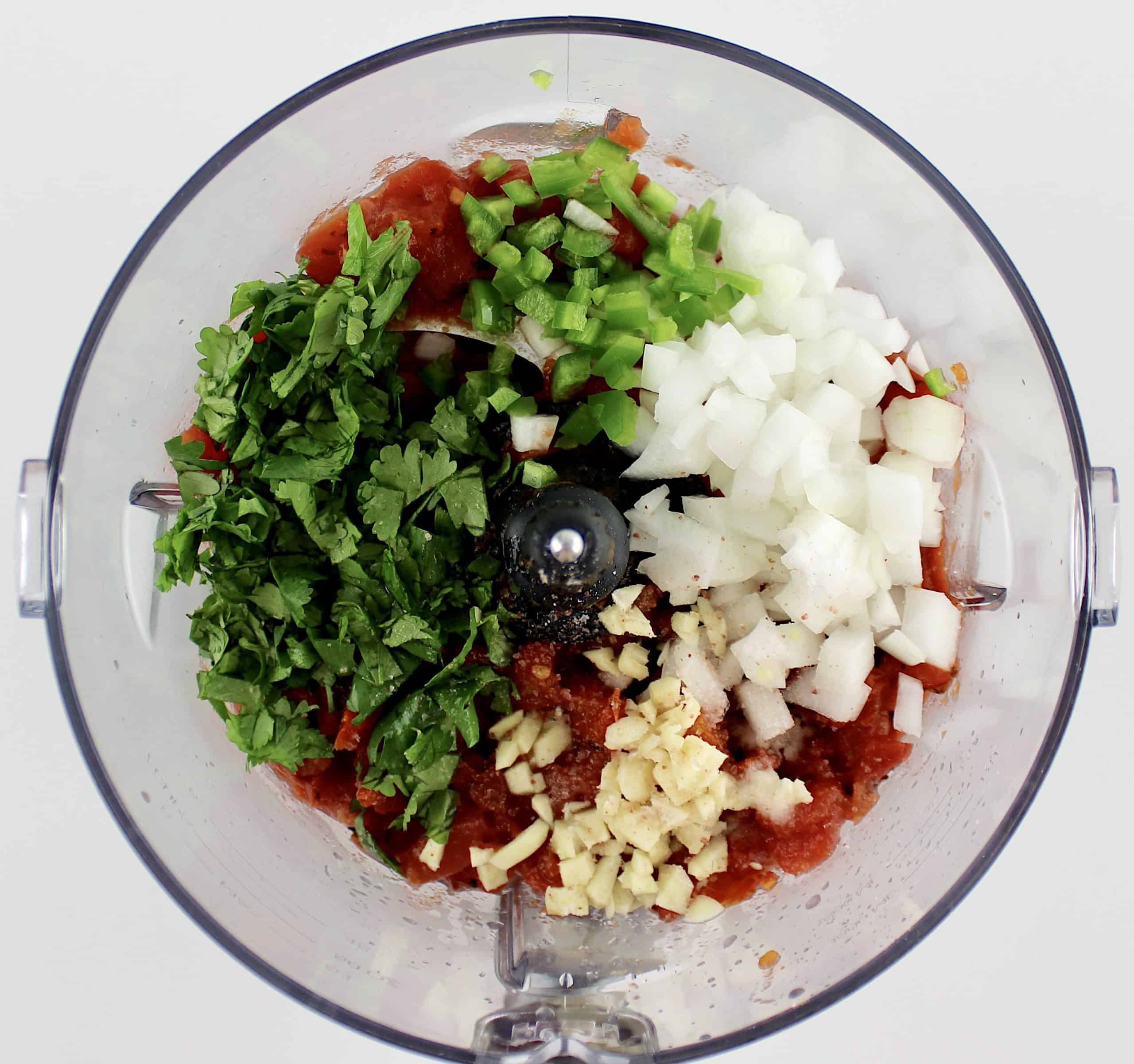 salsa ingredients in bowl of food processor unmixed