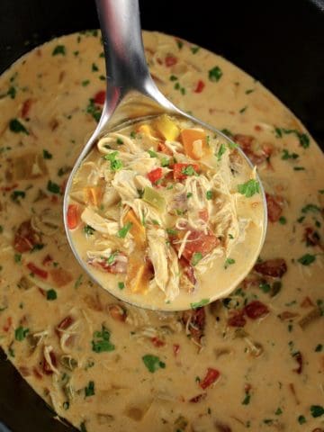 Chicken Fajita Soup in silver ladle over slow cooker