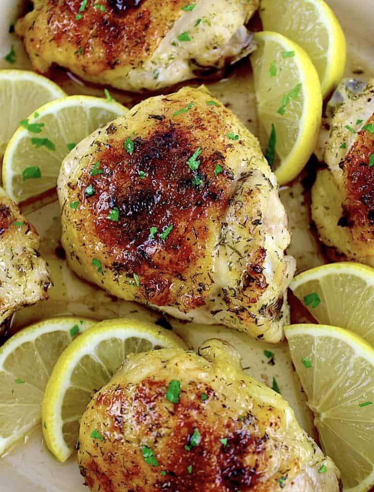 closeup of Baked Chicken Thighs with lemon slices