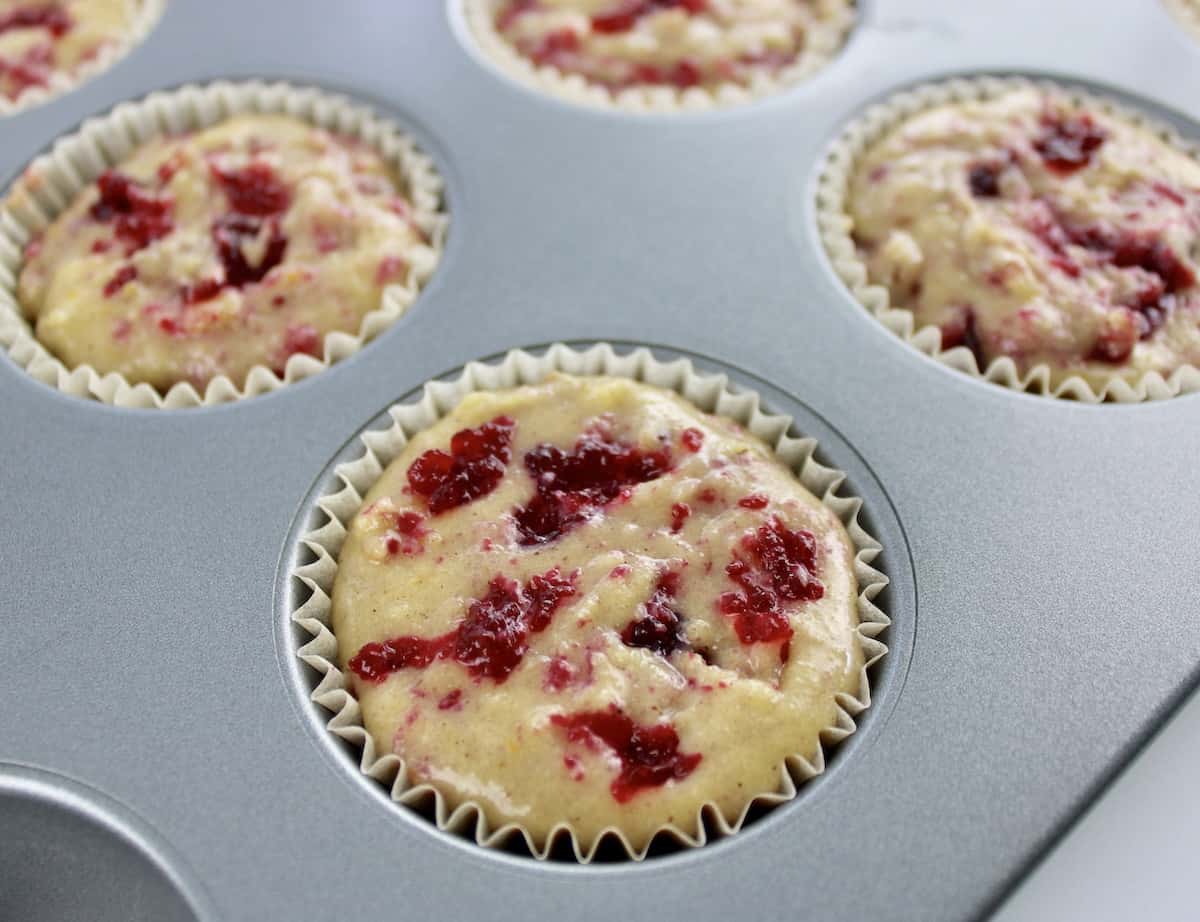 Cranberry Sauce and Walnut Muffins batter in muffin pan unbaked