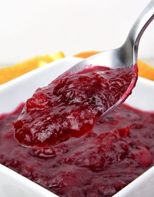cranberry sauce in white bowl with spoonful