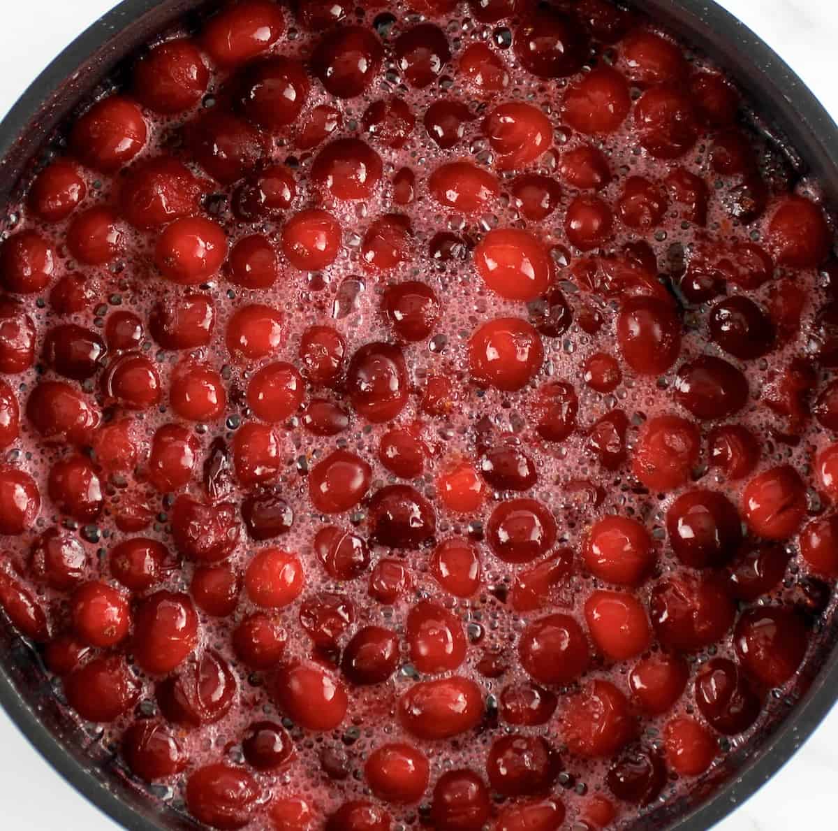 Keto Cranberry Sauce in saucepan partially cooked