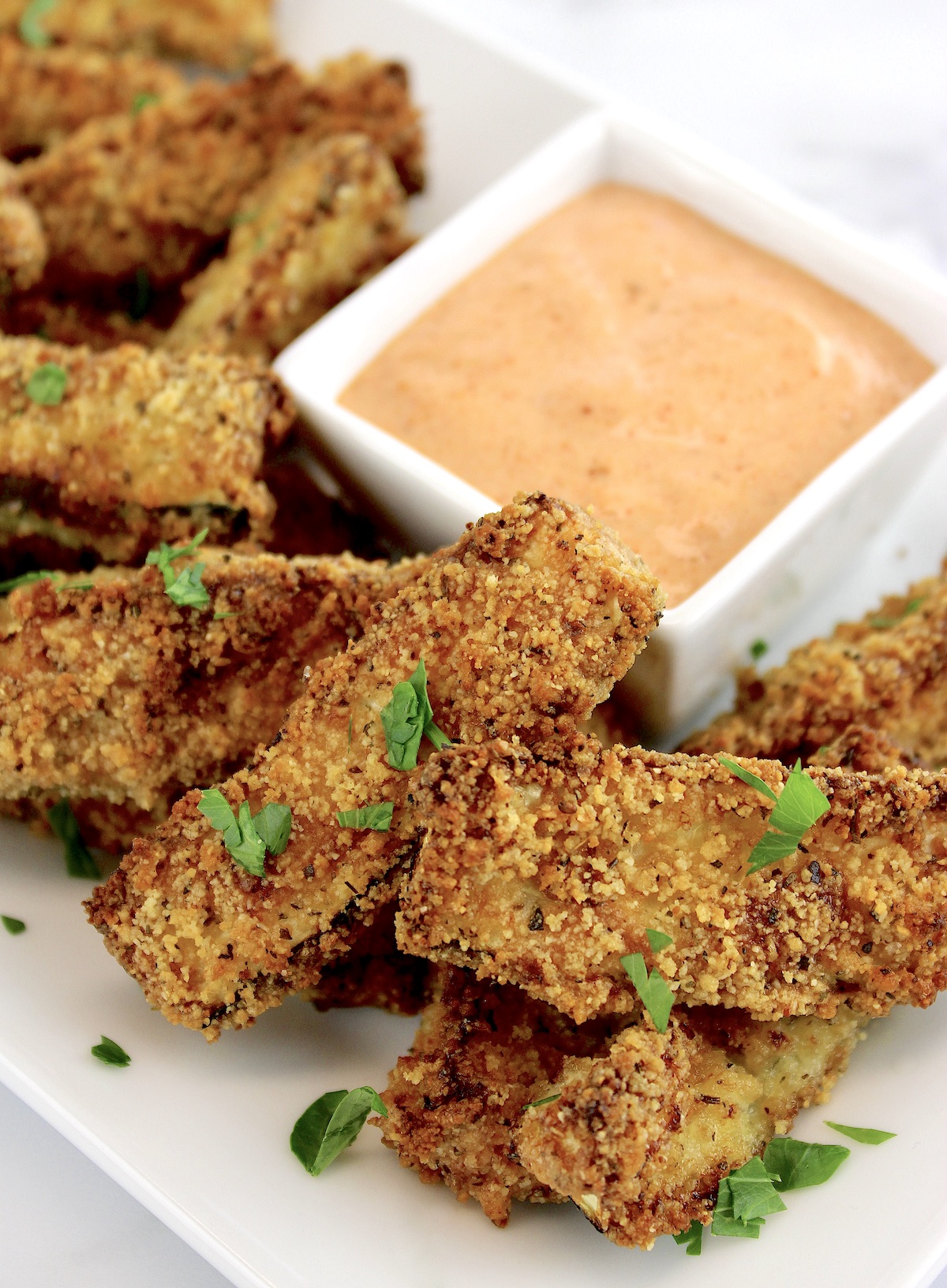 Air Fryer Zucchini Fries with dipping sauce on white plate