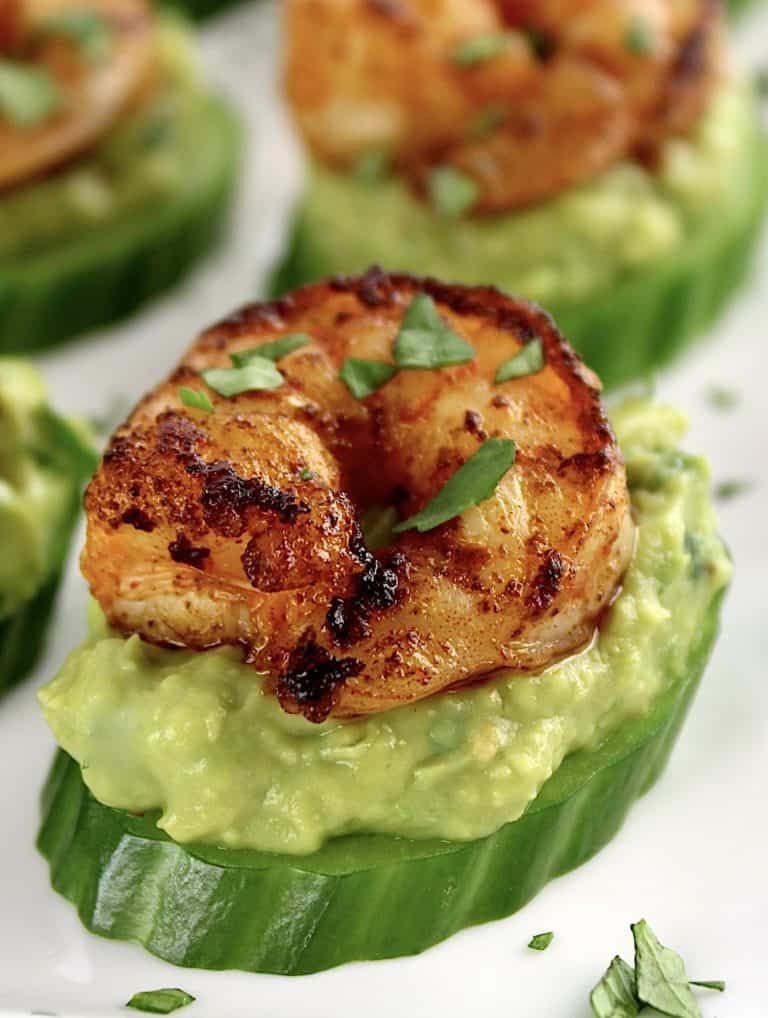 seasoned shrimp on guacamole and cucumber slice