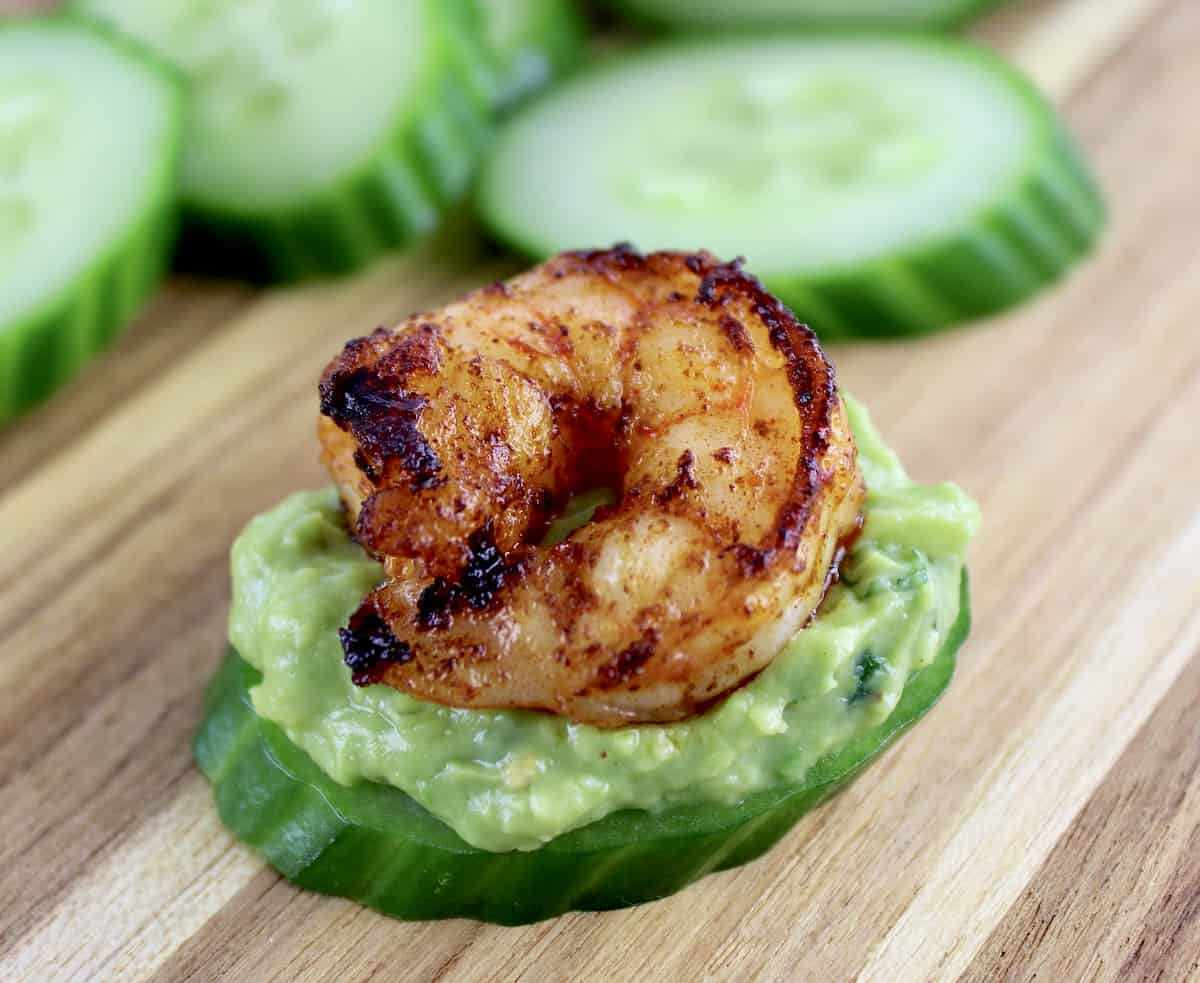 cucumber slice with guacamole and seasoned shrimp on top