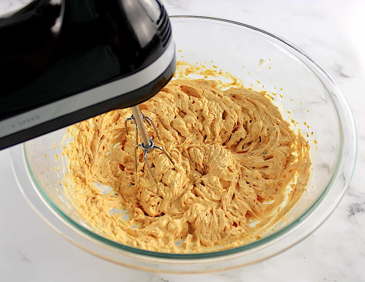 Buffalo Chicken Dip sauce being mixed with hand mixer