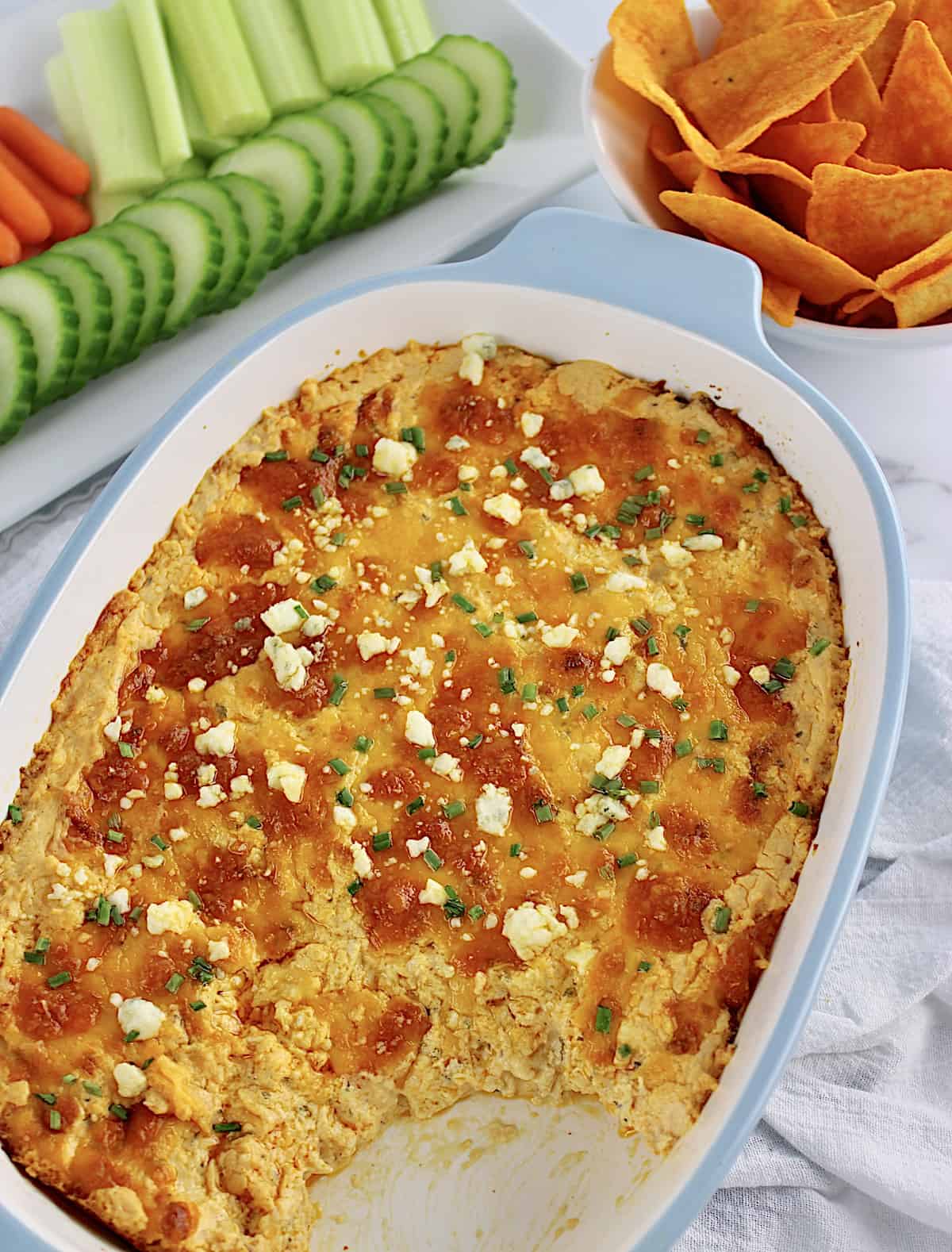 Buffalo Chicken Dip in casserole with some missing