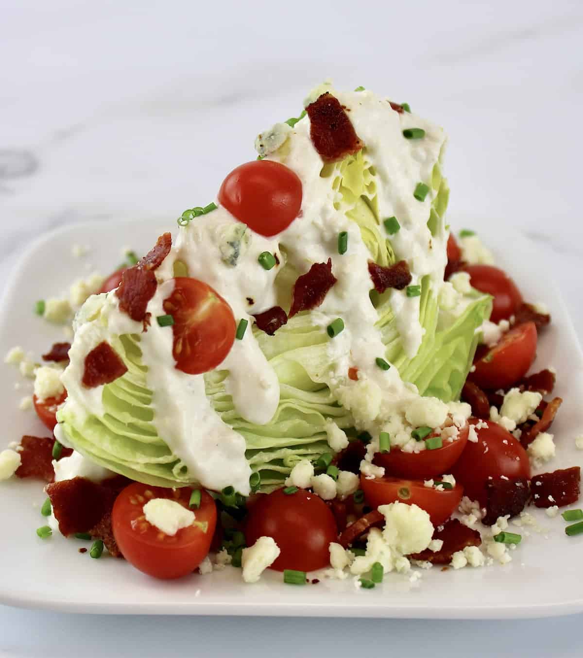 closeup of Classic Wedge Salad on white plate
