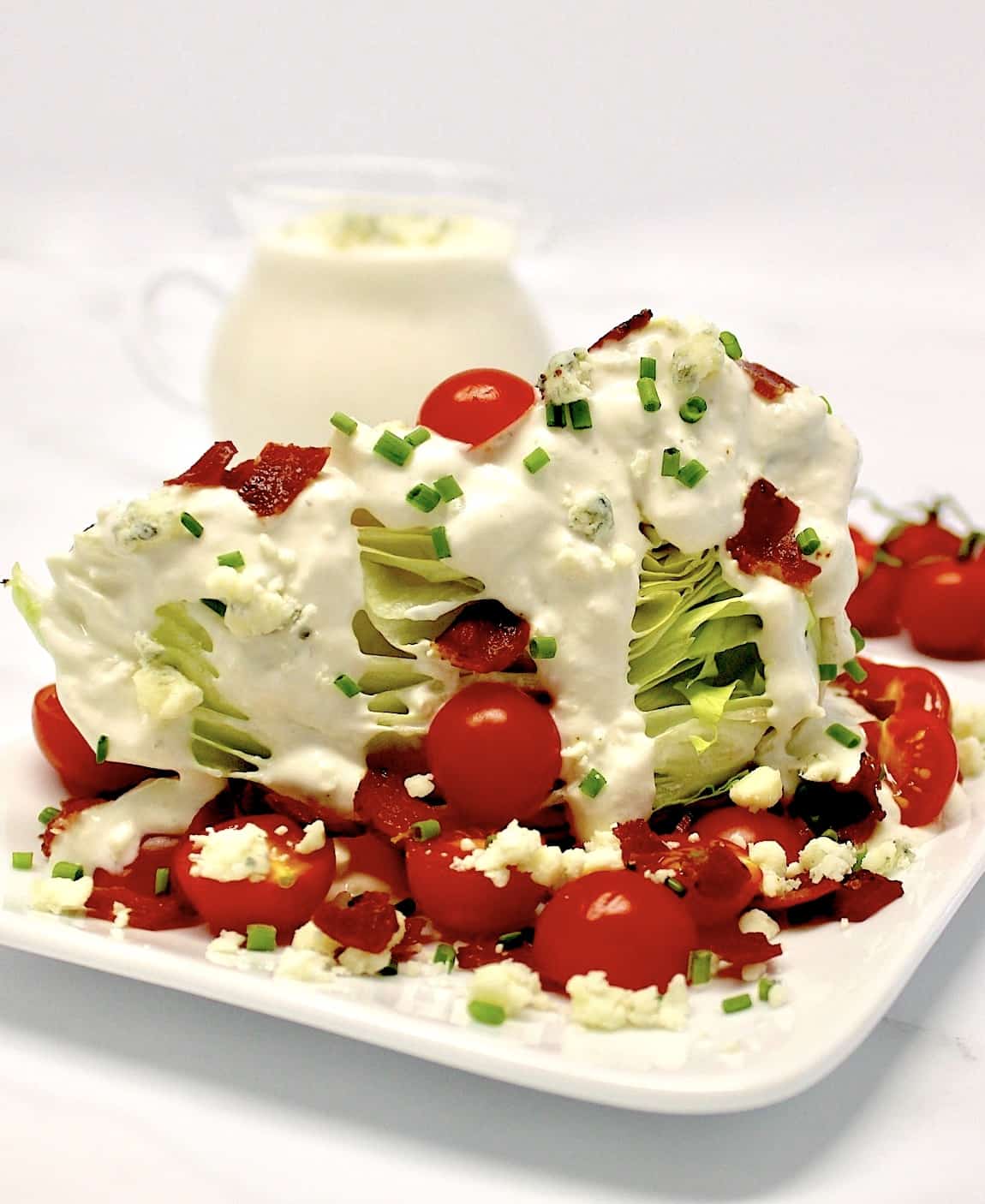 Classic Wedge Salad with blue cheese dressing in background