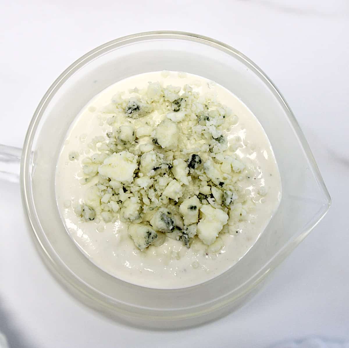 overhead view of Keto Blue Cheese Dressing in glass pitcher