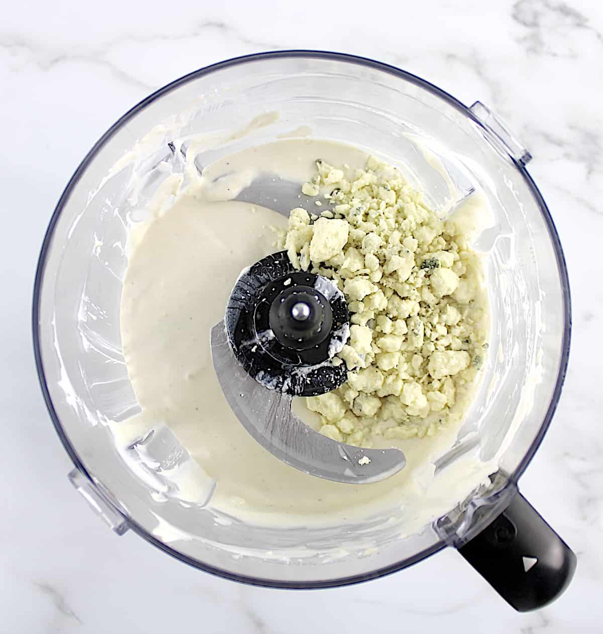 Keto Blue Cheese Dressing with blue cheese crumbles in food processor unmixed