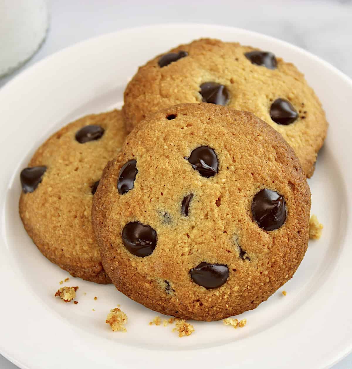 closeup of 3 Keto Chocolate Chip Cookies on white round plate