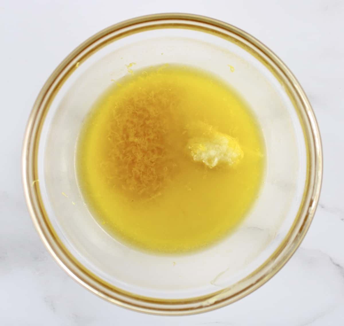 lemon pepper wings butter sauce ingredients in glass bowl unmixed