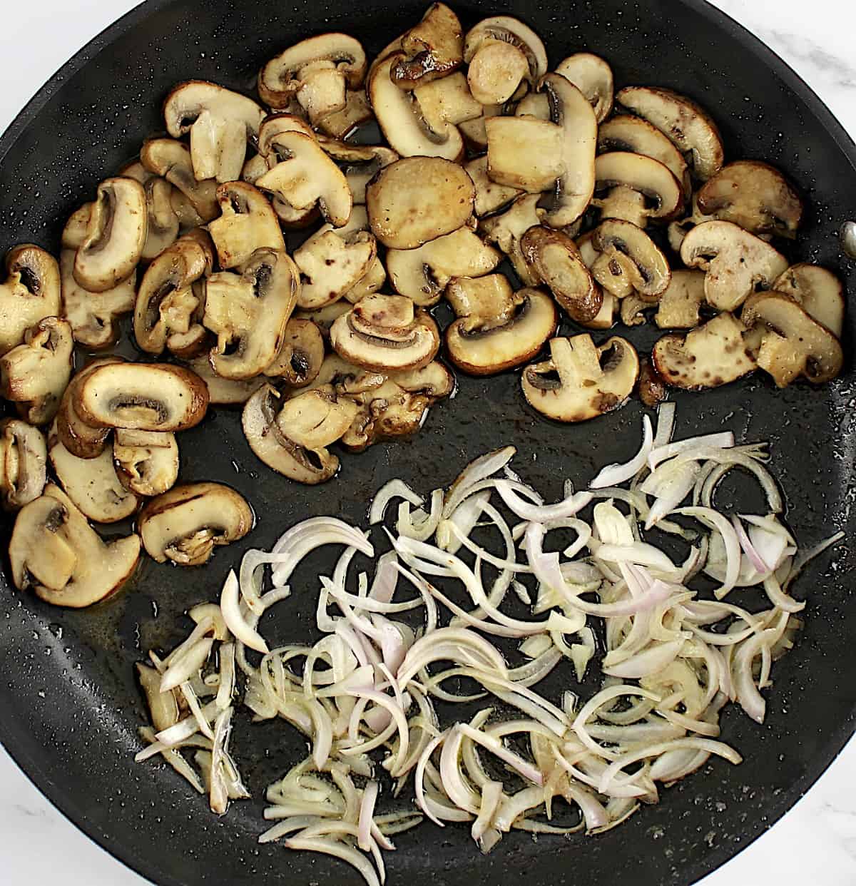 sauteed mushrooms and sliced shallots in skillet