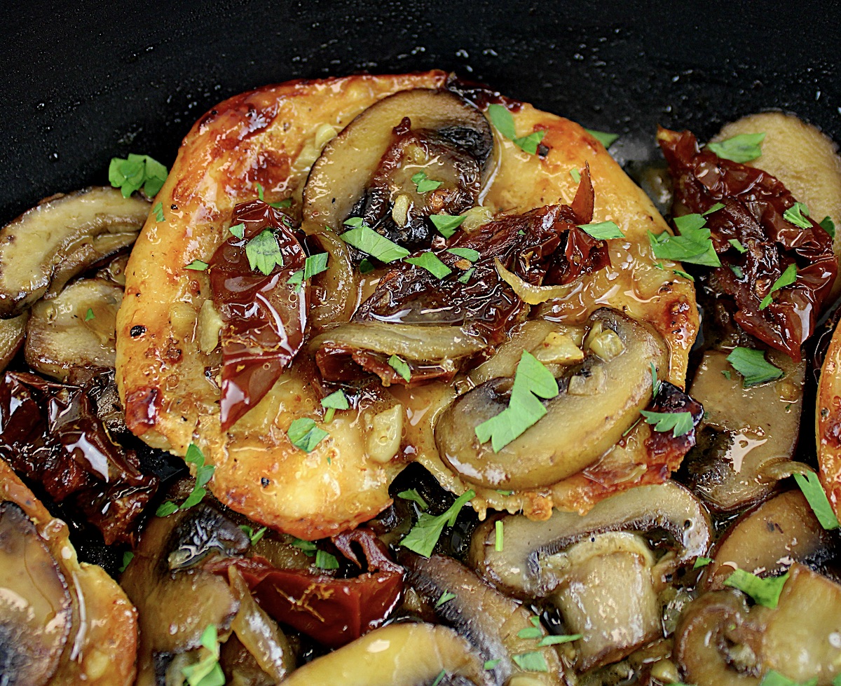 closeup of Mushroom Chicken with Sun-Dried Tomatoes in skillet