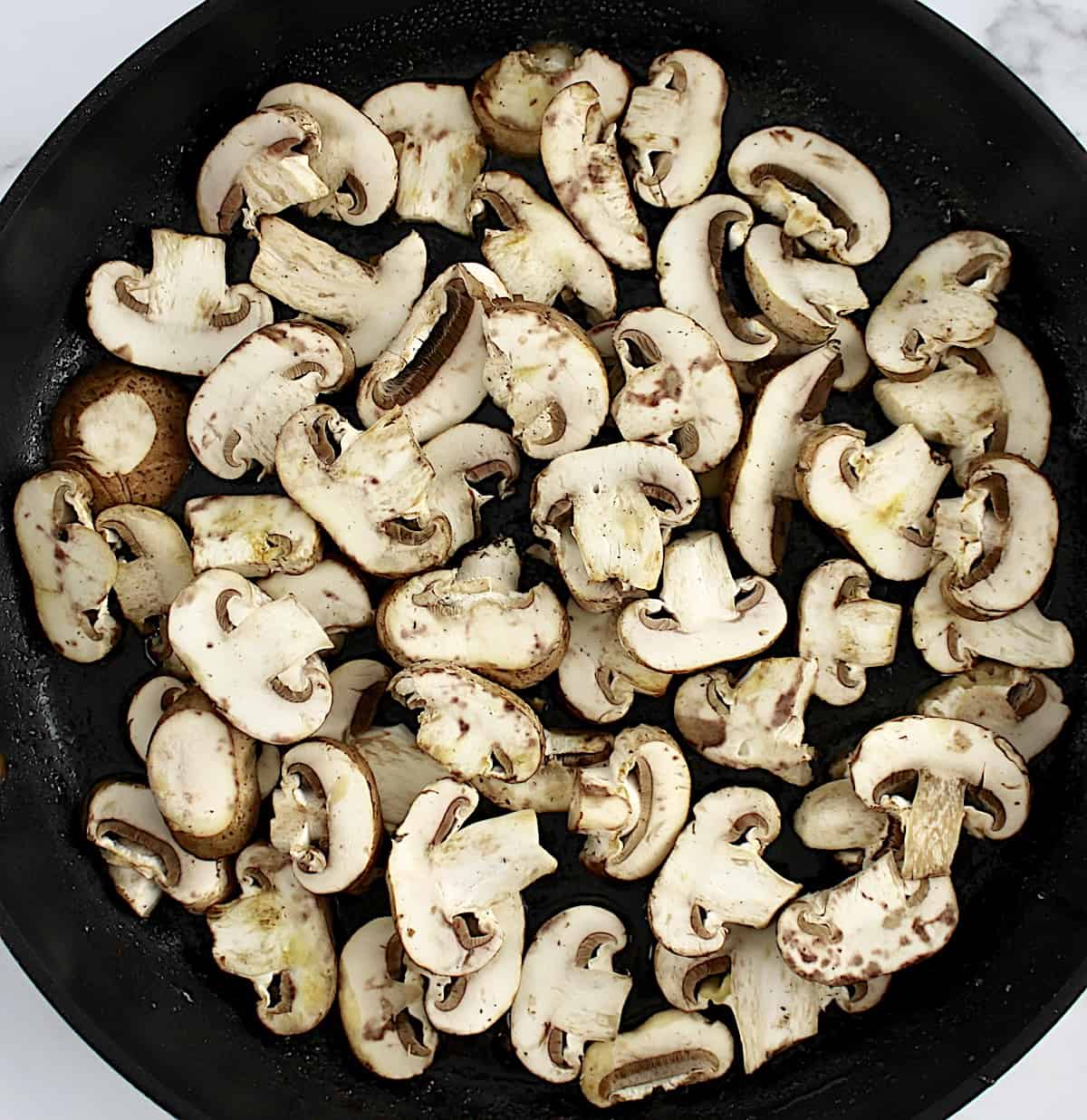 raw mushrooms in skillet