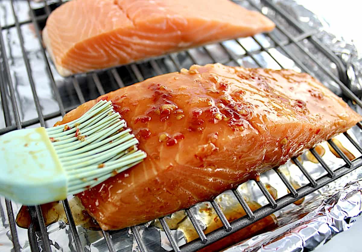 Asian glaze being brushed over salmon onn wire rack