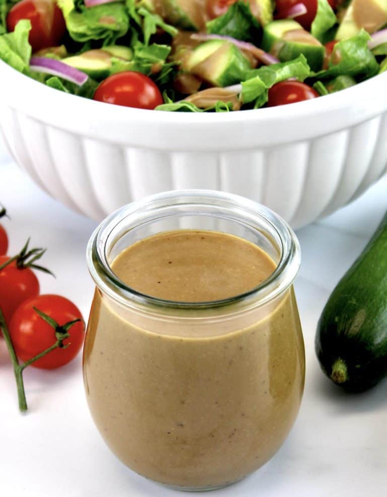 Creamy Balsamic Dressing in glass open jar with salad in background
