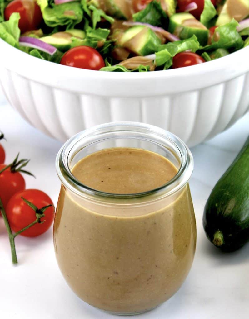 Creamy Balsamic Dressing in glass open jar with salad in background