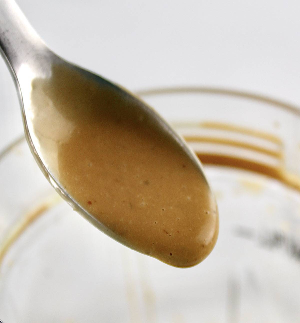 Creamy Balsamic Dressing dripping from spoon