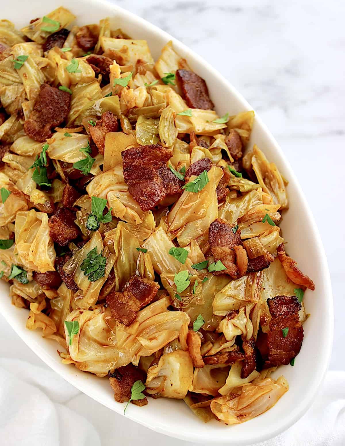 overhead view of Fried Cabbage with Bacon in white bowl