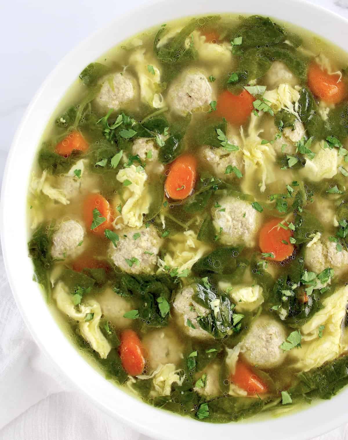 overhead view of Italian Wedding Soup in white bowl