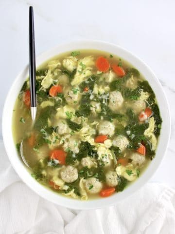 overhead view of Italian Wedding Soup in bowl with spoon