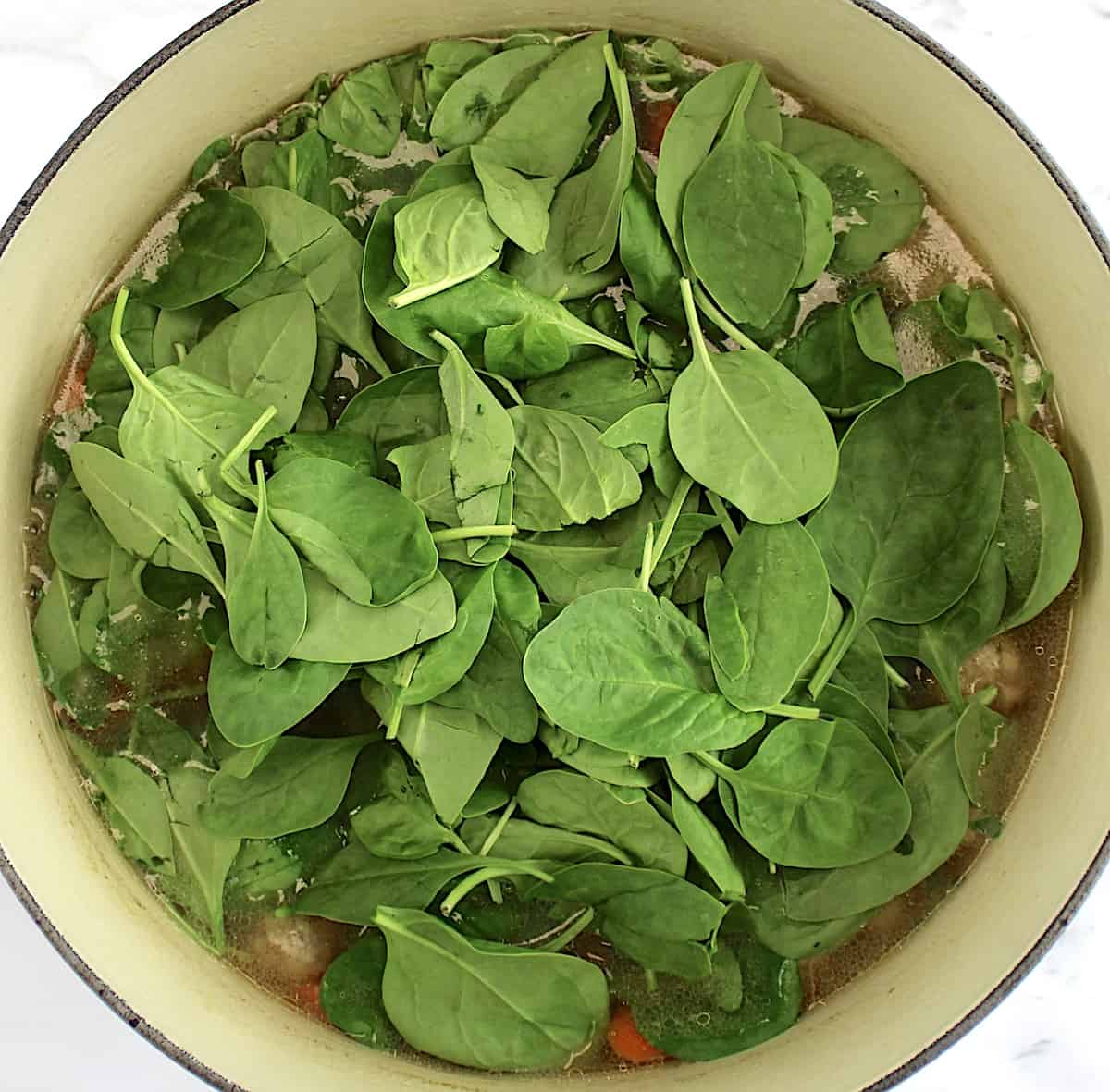 baby spinach in pot of Italian Wedding Soup