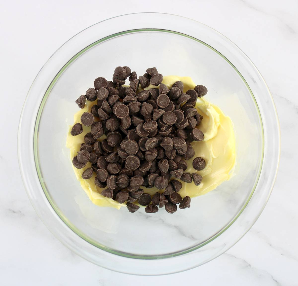 chocolate chips and butter in glass bowl