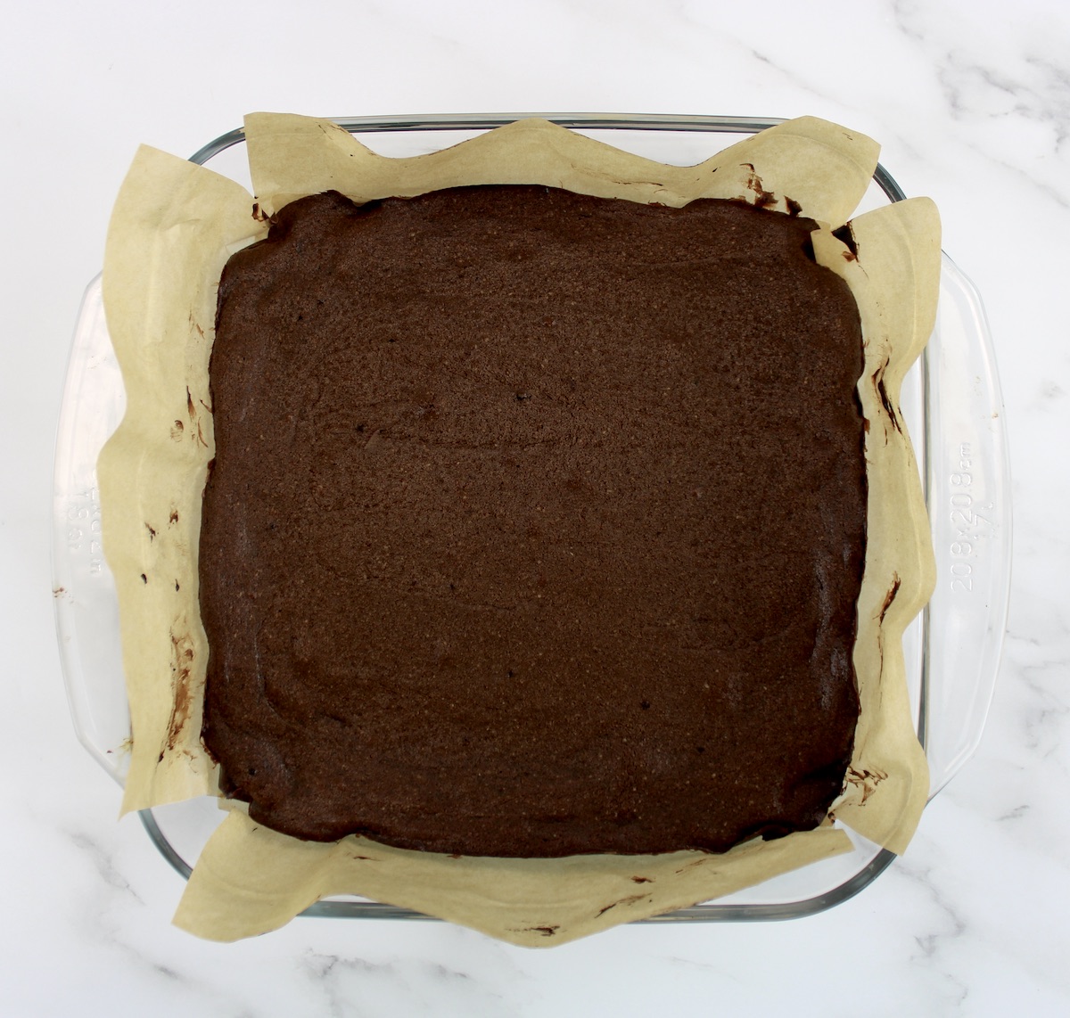 Keto Fudge Brownies in glass baking dish lined with parchment