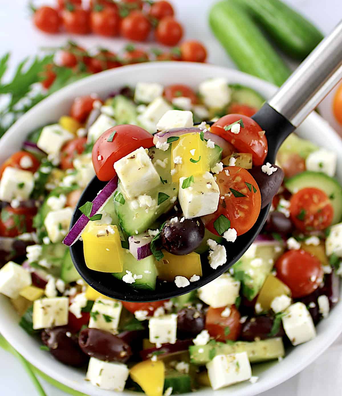 Keto Greek Salad with Dressing in black serving spoon over salad